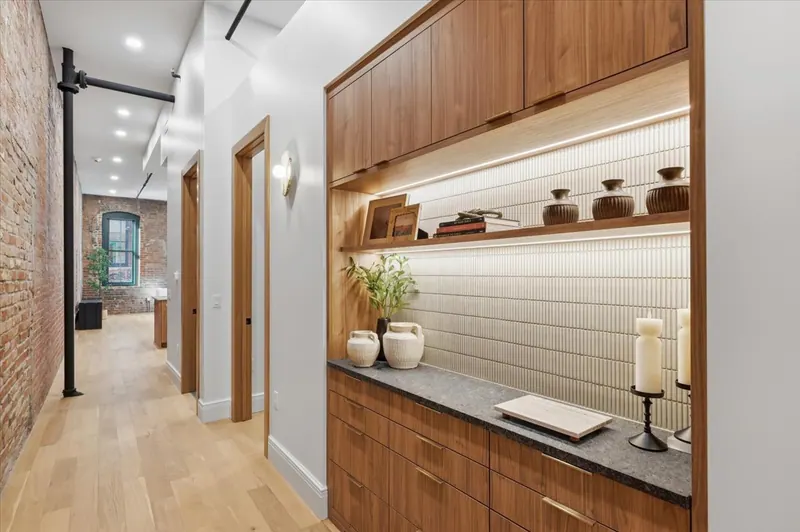 Model Unit 209 entry with built-in walnut credenza