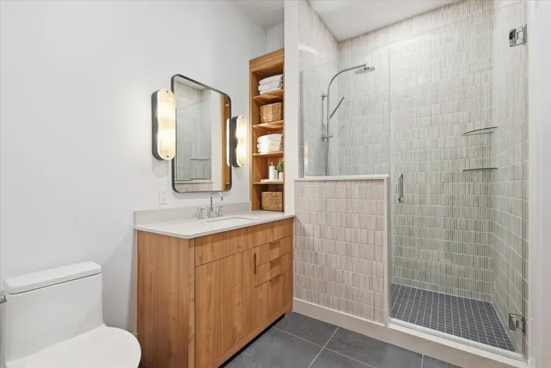 Model Unit 209 bathroom with tiled walk-in shower